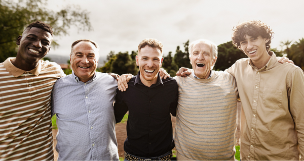 Men in their 60s standing shoulder to shoulder, smiling at the camera